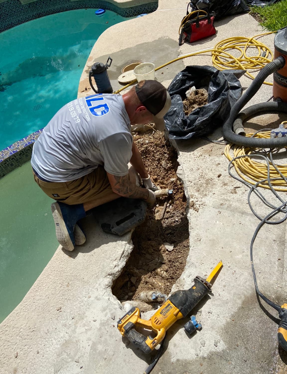 Aquatic Leak Detection crew excavating and repairing an underground pool plumbing line